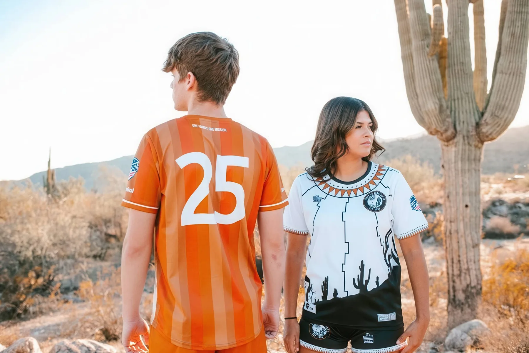 State 48 players wearing the copper and white 2025 kits beside a saguaro cactus